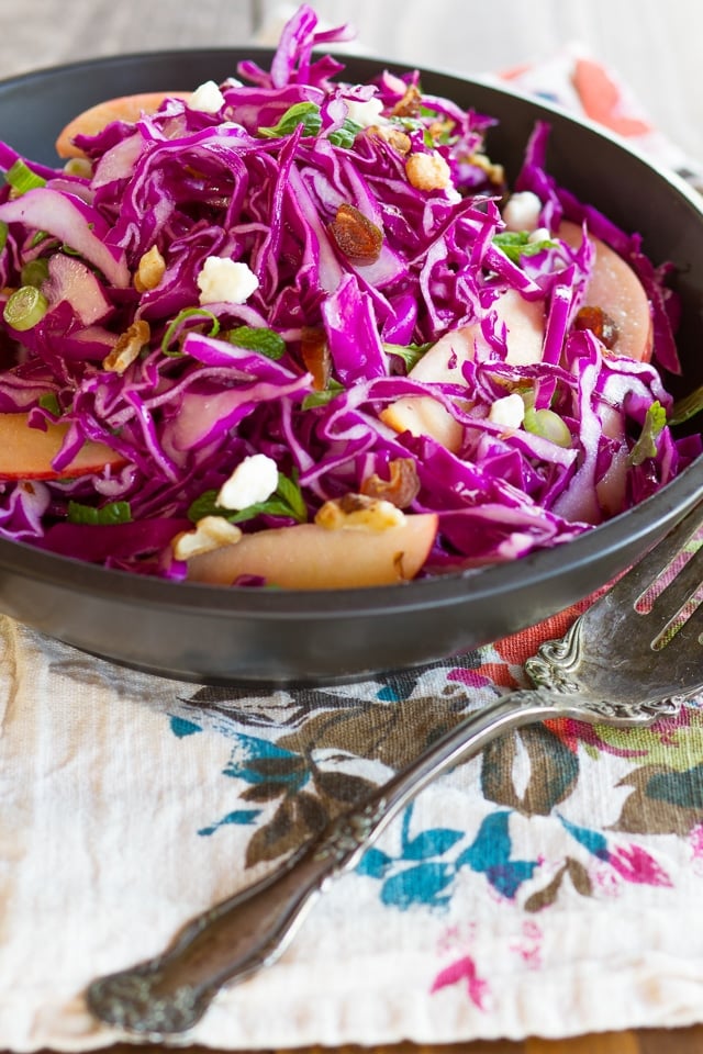 Red Cabbage Apple Salad with Blue Cheese & Walnuts - Unique and delicious cabbage salad recipe with apples, blue cheese, toasted walnuts, dates, green onions, mint and a tantalizing creamy dressing.