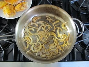 Sliced onions in saute pan.