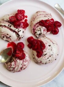 Decadent raspberry cacao ripple rochers on a white plate with spoons