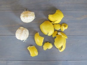 Lemons peeled with peels beside them.