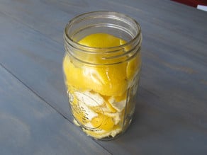 Lemon peels in open mason jar.