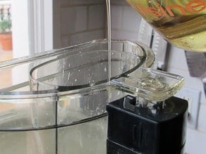 Drizzling oil into running food processor.