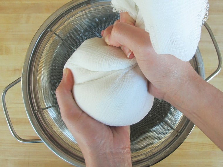 Squeezing coconut milk out of cheesecloth..
