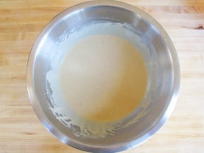 Wet ingredients for waffle in a mixing bowl.