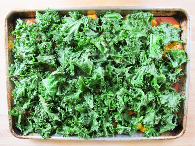 Kale on top of Butternut Squash on a baking tray