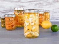 Jars of organic vinegar cleanser with citrus peels steeping.