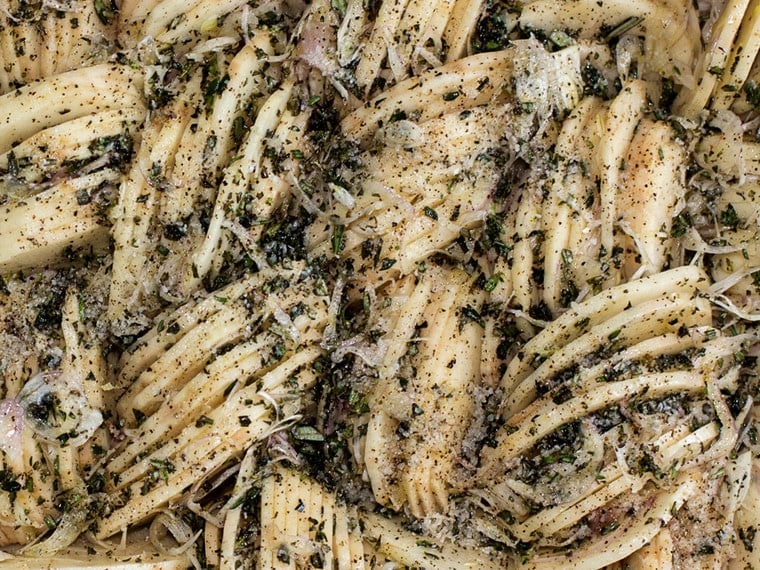 Sliced potatoes arranged vertically in a baking dish.