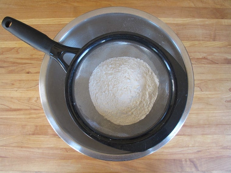 Flour sifting through strainer.