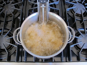 Chicken frying on the stovetop.