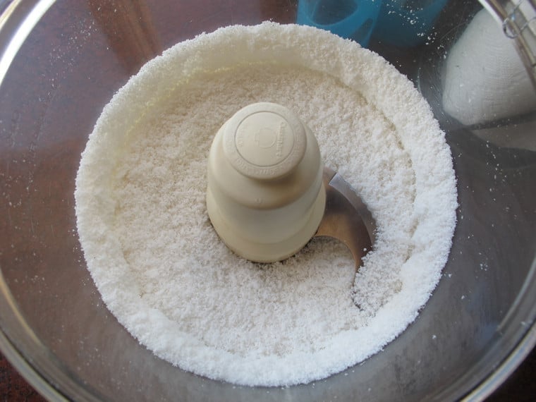 Dried coconut in a food processor.