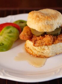 Fried Chicken Sliders Recipe - Crispy, Flavorful Fried Chicken Thighs on Freshly Baked Biscuits with Pickle Slices and a Drizzle of Honey. #southern #comfortfood