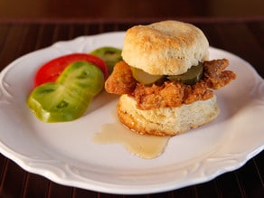 Fried Chicken Sliders Recipe - Crispy, Flavorful Fried Chicken Thighs on Freshly Baked Biscuits with Pickle Slices and a Drizzle of Honey. #southern #comfortfood