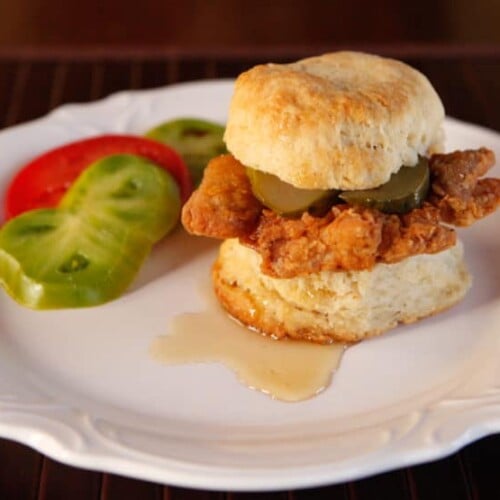 Fried Chicken Sliders Recipe - Crispy, Flavorful Fried Chicken Thighs on Freshly Baked Biscuits with Pickle Slices and a Drizzle of Honey. #southern #comfortfood