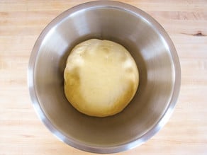 Dough ball resting in a bowl.
