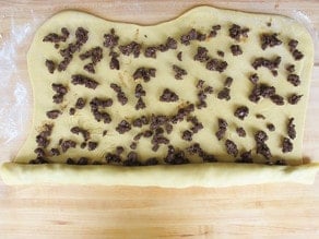 Chocolate filling spread on a dough rectangle.