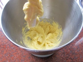 Eggs added to butter in mixer.