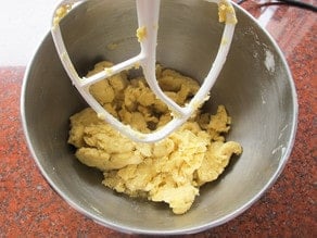 Flour added to butter and eggs in mixer.