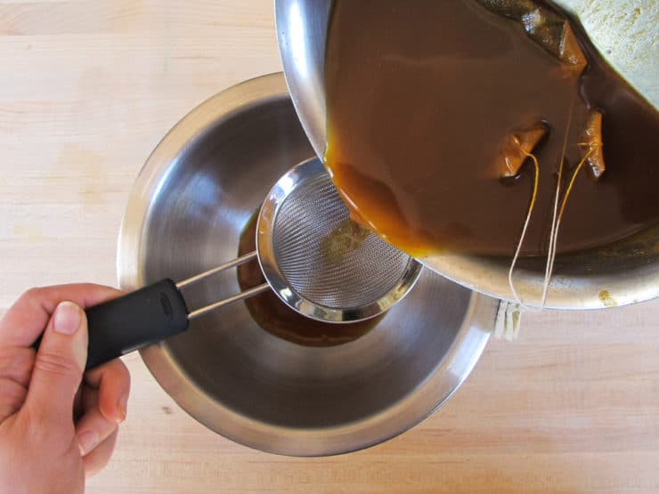 Straining spices from tea.