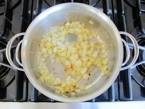Onions sauteeing in a pan.