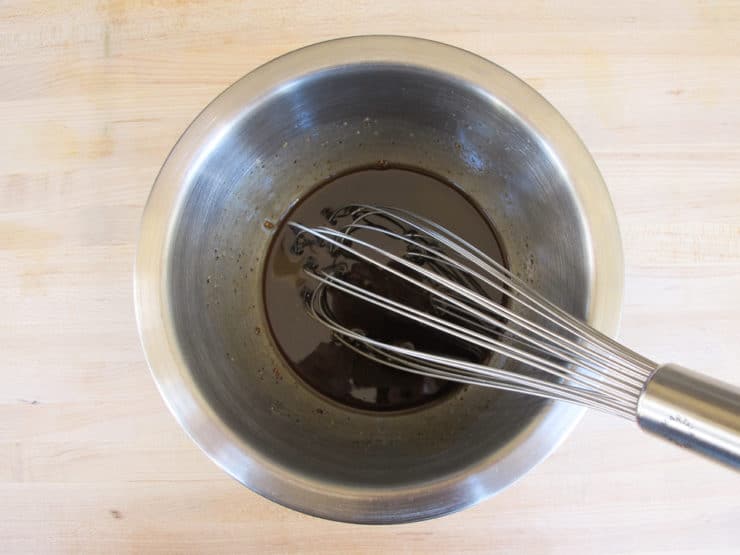 Bowl of salad dressing being whisked.