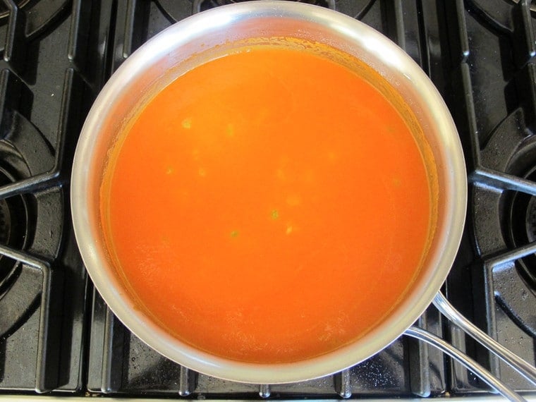 Tomato rice soup on stove.