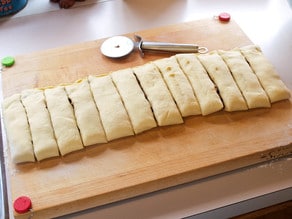 Rolled dough cut into 12 sections.