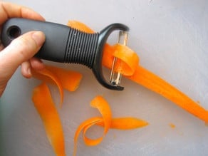Peeling ribbons of carrot.