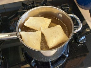 Sopapillas frying on the stove.