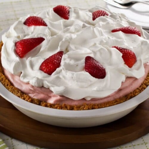 Strawberry Chiffon Pie - Light and Fluffy Strawberry Filling Inside of a Crisp Graham Cracker Crust and Topped with Whipped Cream. Time-Tested Family Recipe.