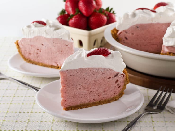 A slice of Strawberry Chiffon Pie on a plate with a fork