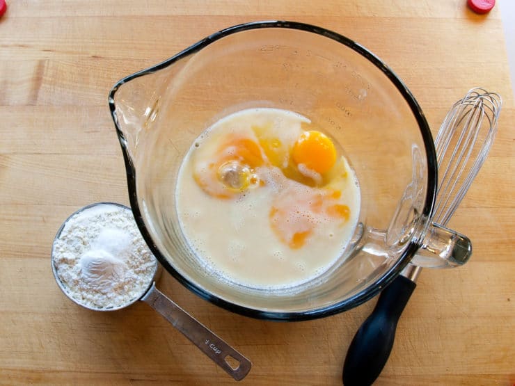 Sugar milk and eggs with whisk