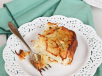 A slice of Potato Kugel cake on a plate with a fork