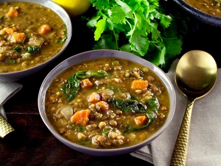 A bowl of lemon lentil soup with spinach and carrots