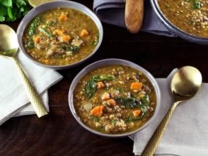 Two bowls of Lentil Spinach Soup with Lemon, filled with vegetables and carrots