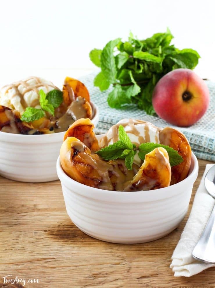 Grilled Peach Sundae with Brandy Butterscotch Sauce - Recipe for grilled ripe peaches and creamy caramelized sauce over vanilla frozen yogurt. 