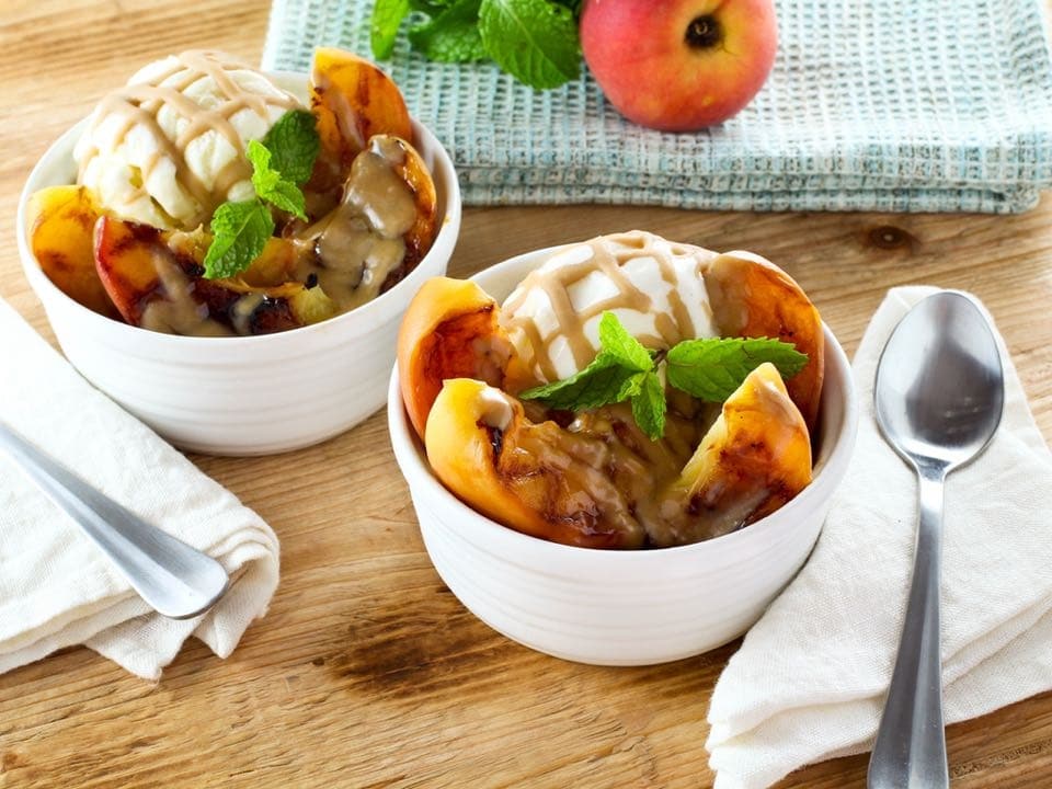 Grilled Peach Sundae with Brandy Butterscotch Sauce - Grilled ripe peaches and brandy butterscotch sauce served over tart vanilla frozen yogurt. Kosher, dairy.