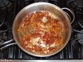Sautéing onion and tomato paste to make mnazaleh, a traditional Middle Eastern Druze recipe.