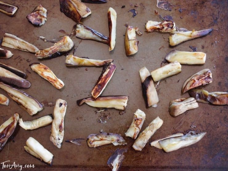 Roasted eggplant pieces browned on baking sheet.