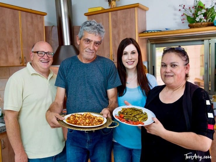 Paul Nirens, Basis family, and Tori Avey present traditional Druze dishes in kitchen - Daliat Carmel, Israel.