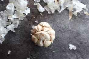 Whole head of garlic with whole cloves, outer papery layers of skin removed.