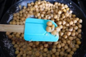 A close-up image of a bowl filled with cooked chickpeas
