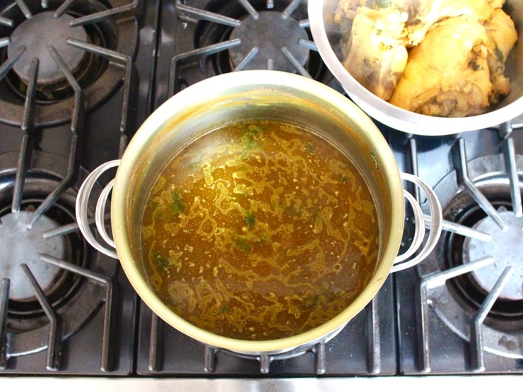 Large stock pot filled with soup broth.