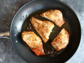 4 baked and broiled Teriyaki Black Cod fillers in skillet with olive oil.