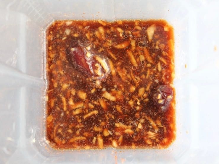 Dates, coconut aminos, citrus, garlic and spice in blender before blending.