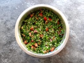 Overhead shot of quinoa tabbouleh salad in a mixing bowl.