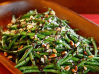 A plate of green beans drizzled with balsamic date reduction