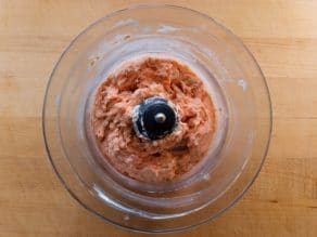 Ground lox in a food processor bowl.