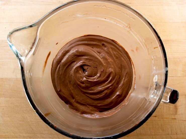 Chocolate pie filling in a clear glass mixing bowl.