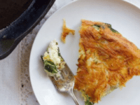 A plate containing a Spinach Frittata with Potato Crust omelet