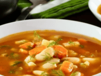 A bowl of Butter Bean Soup with colorful vegetables and chunks of carrots